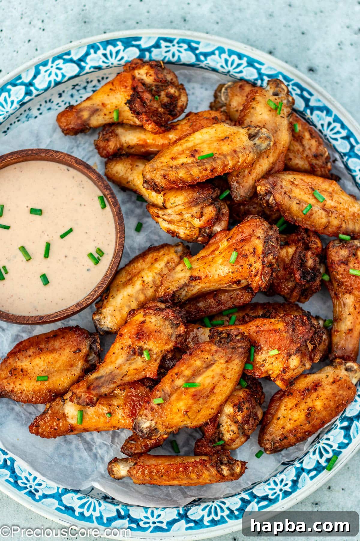 Crispy Baked Dry Rub Wings 2 Crispy Baked Dry Rub Chicken Wings served alongside a bowl of creamy ranch dipping sauce.