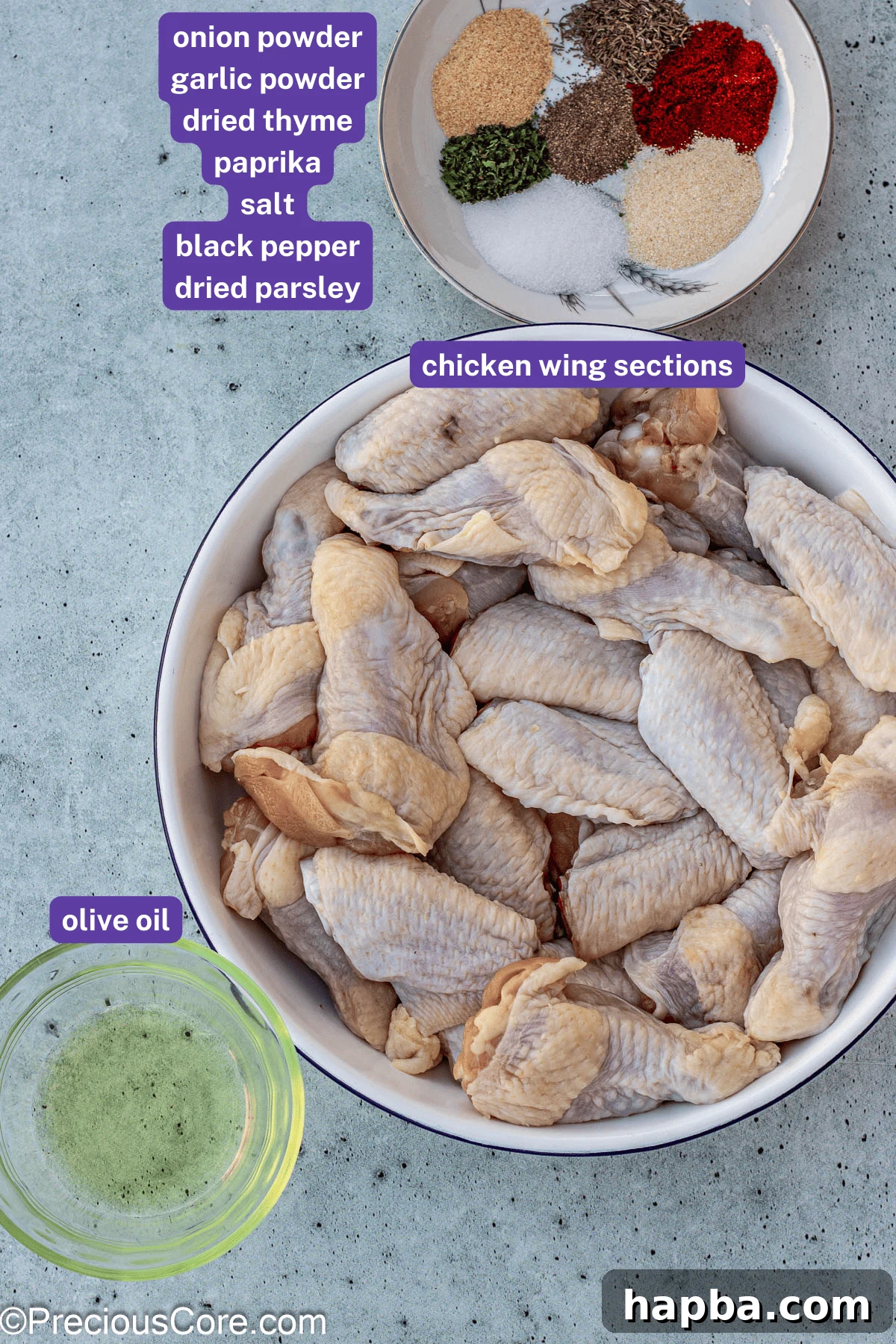Crispy Baked Dry Rub Wings 4 Selection of ingredients for dry rub chicken wings laid out with labels, including fresh chicken wings, olive oil, and various spices.