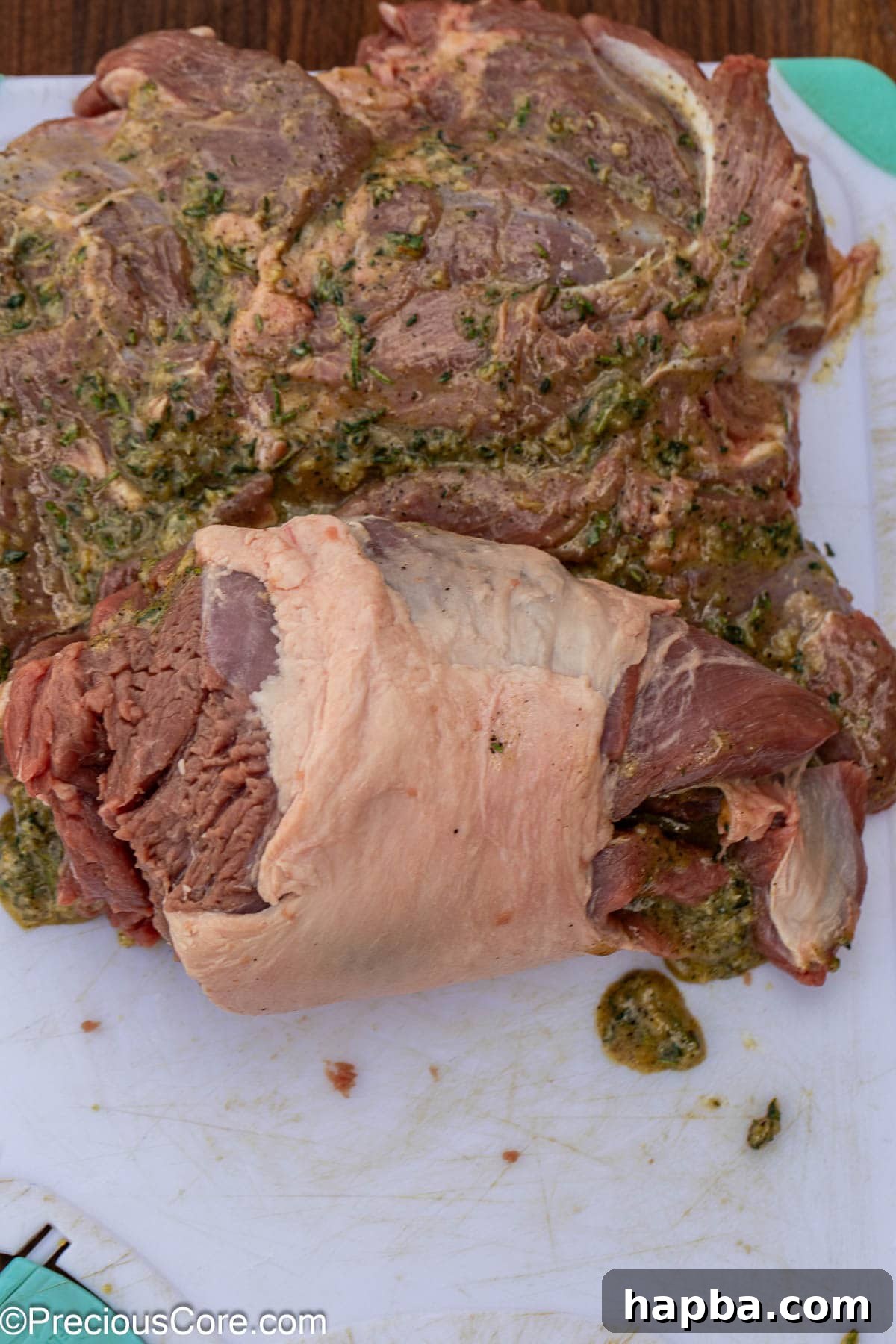 Succulent Boneless Roast Lamb 12 Rolling a boneless lamb leg into a log shape for roasting.