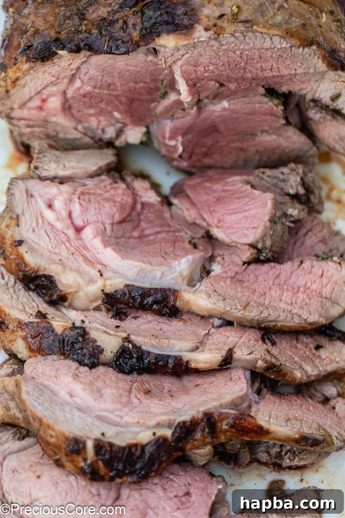 Succulent Boneless Roast Lamb 20 A close-up of freshly sliced lamb roast, showing its juicy texture.