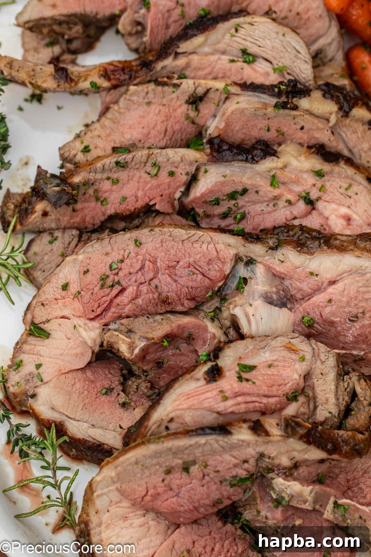 Succulent Boneless Roast Lamb 3 A close-up view of the perfectly browned and sliced lamb roast.