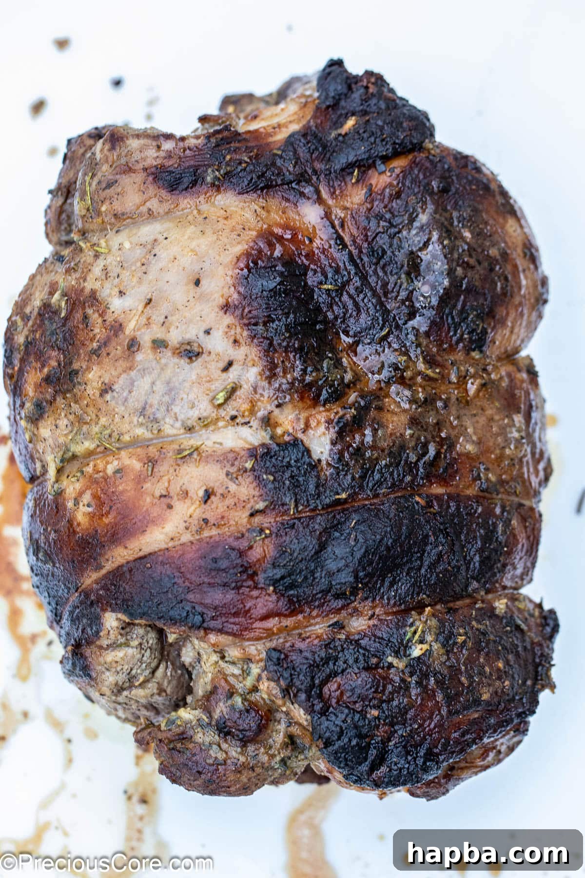Succulent Boneless Roast Lamb 4 A whole roasted boneless leg of lamb, perfectly golden brown.