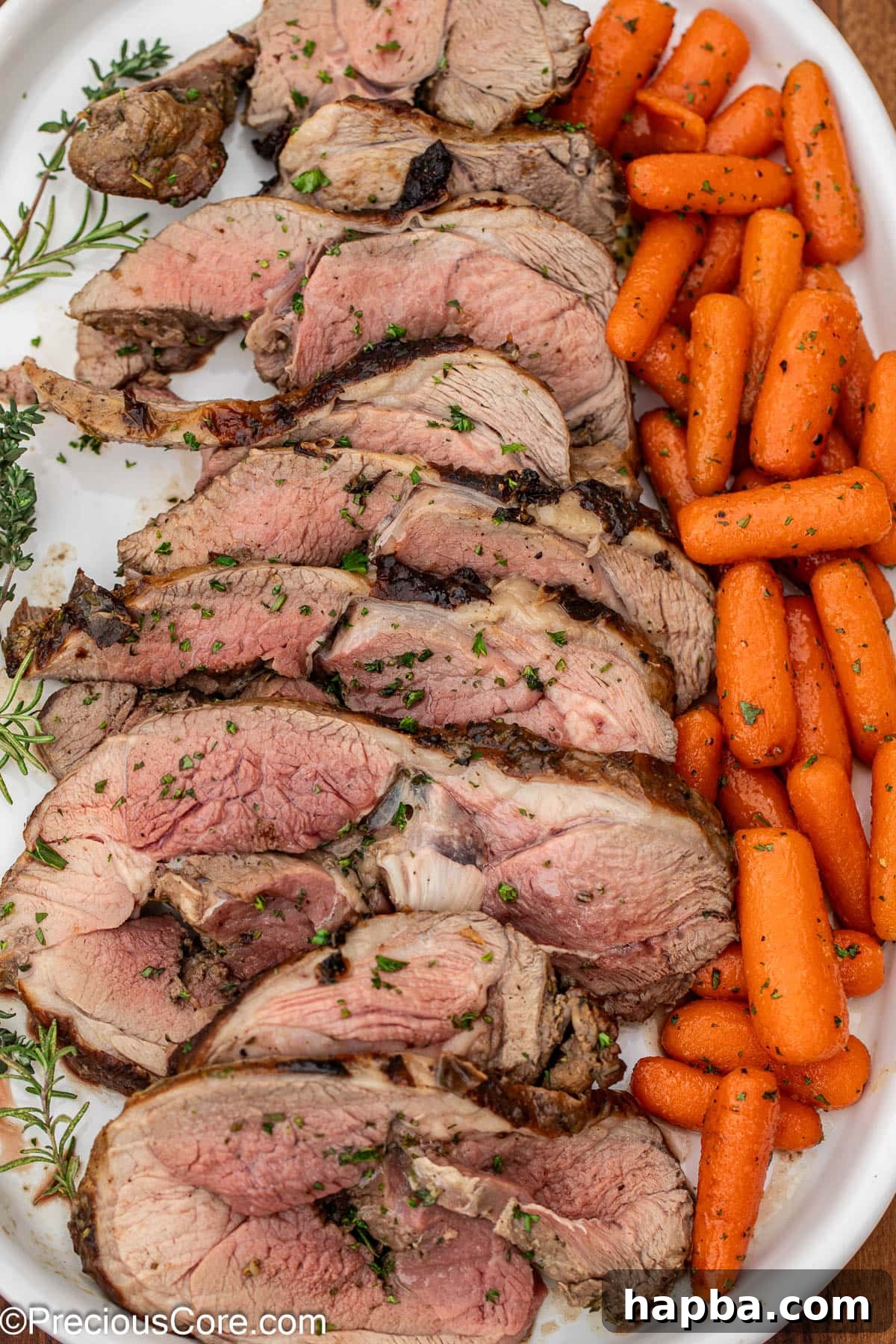 Succulent Boneless Roast Lamb 5 A delectable lamb roast slices served on a platter with glazed carrots.