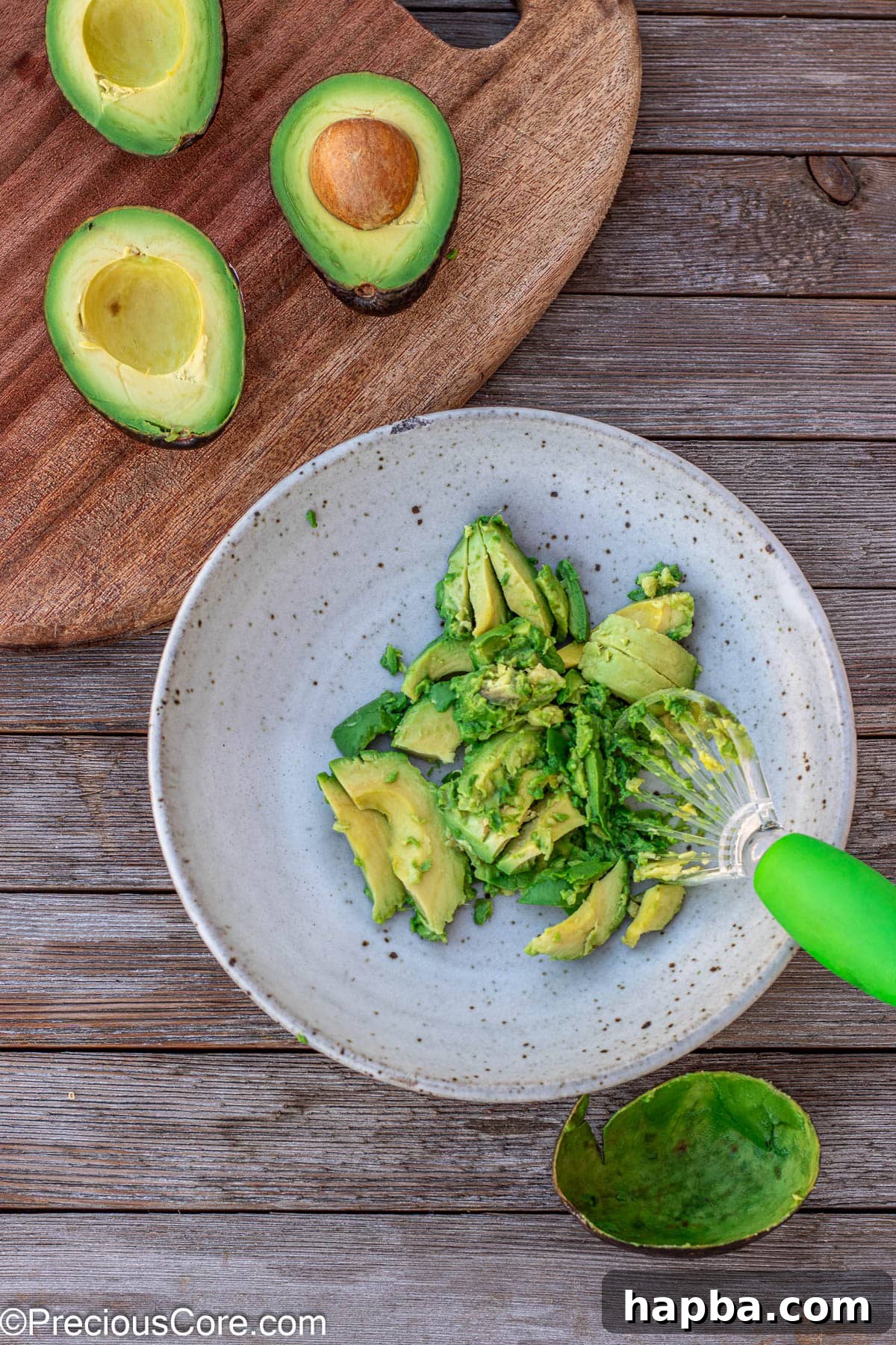 Effortless 4 Ingredient Guacamole 6 Scooped avocado flesh placed neatly into a mixing bowl, ready for mashing.