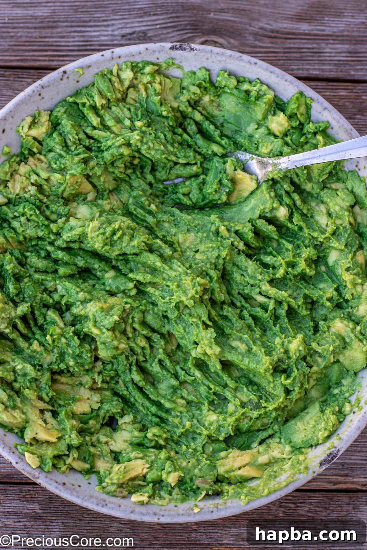 Effortless 4 Ingredient Guacamole 8 Mashed avocados in a bowl, showing the creamy texture achieved before adding other ingredients.