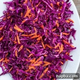 Vibrant red cabbage slaw on a platter, fresh and crunchy.