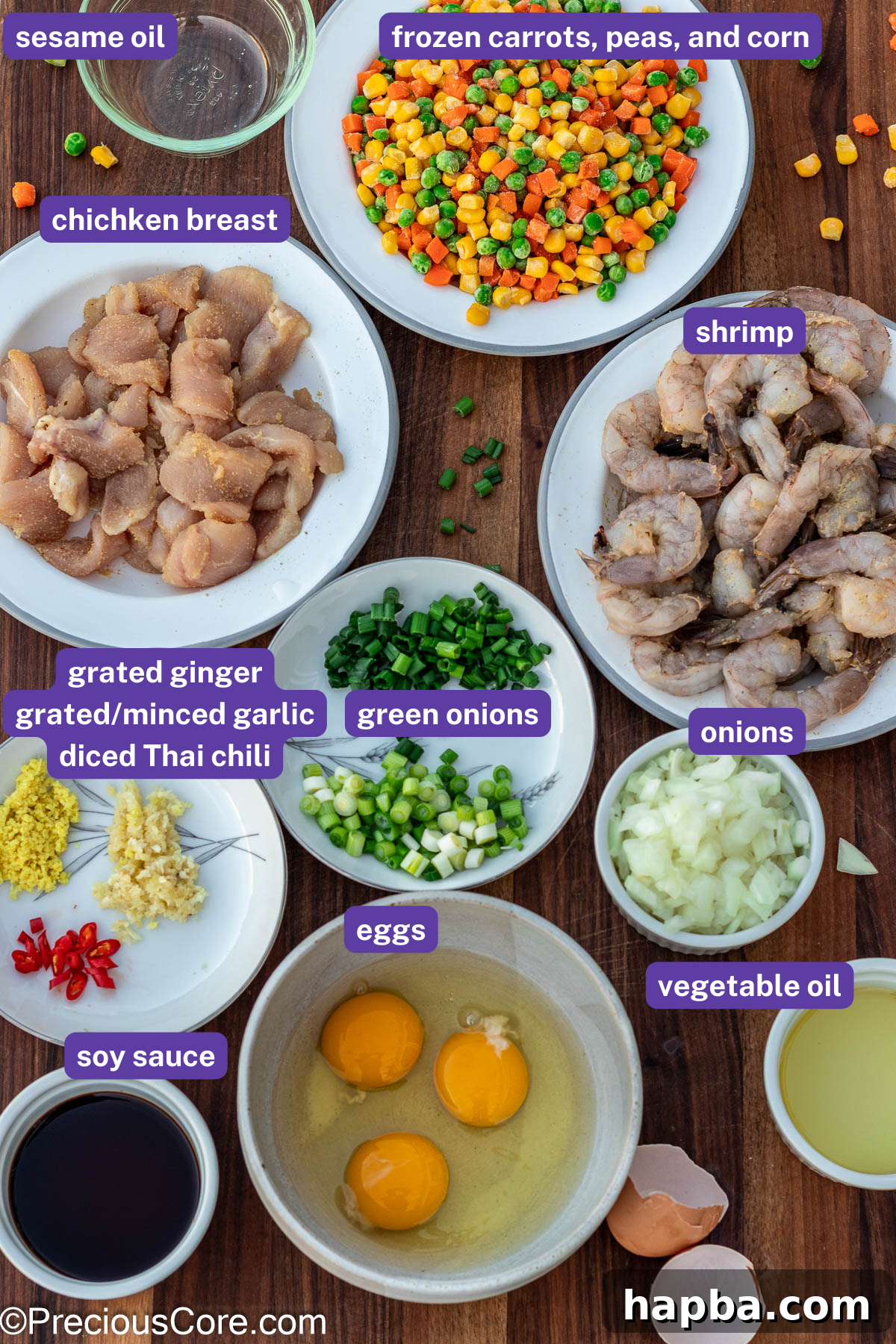A vibrant display of all the fresh ingredients meticulously arranged and labeled for the shrimp and chicken fried rice recipe.