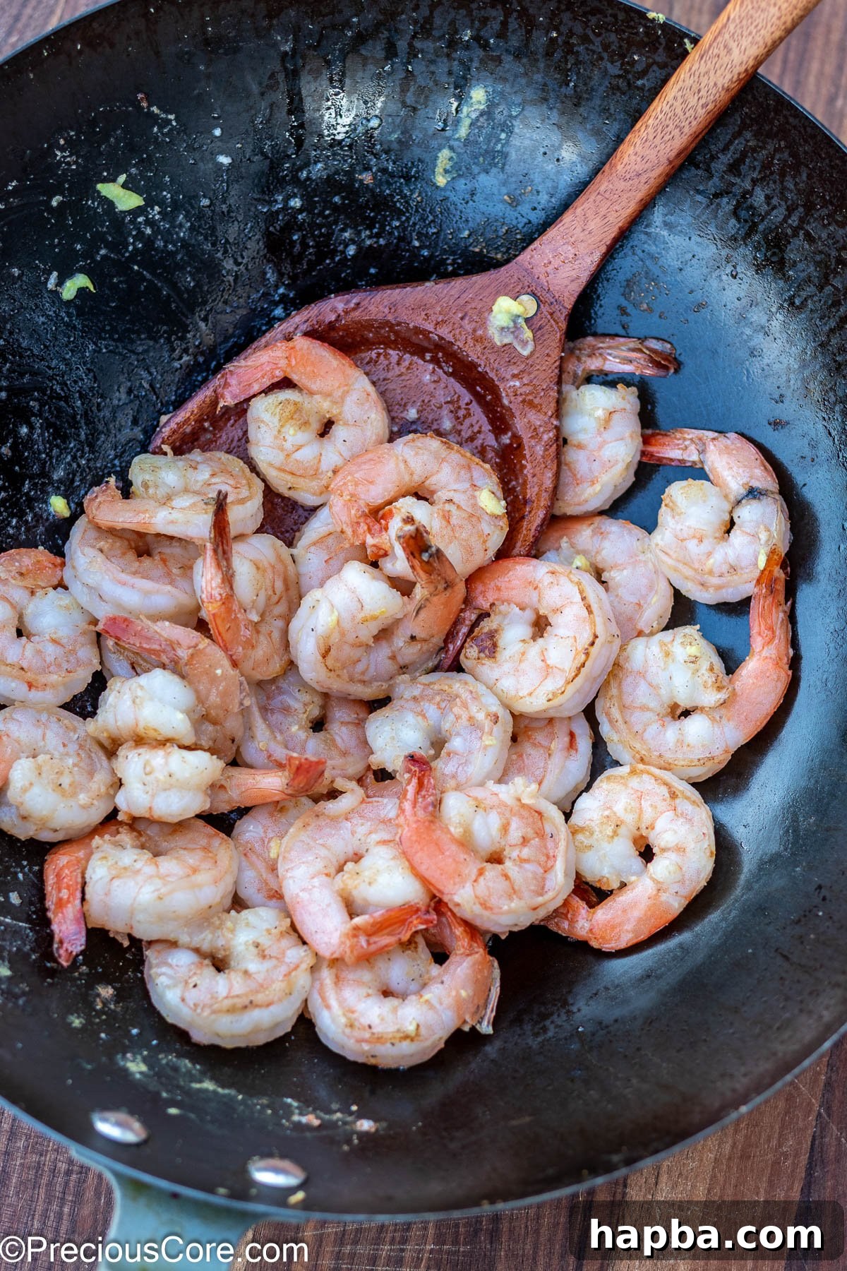 Succulent, pink shrimp, expertly cooked and lightly seared, resting in a wok, ready to join the fried rice.