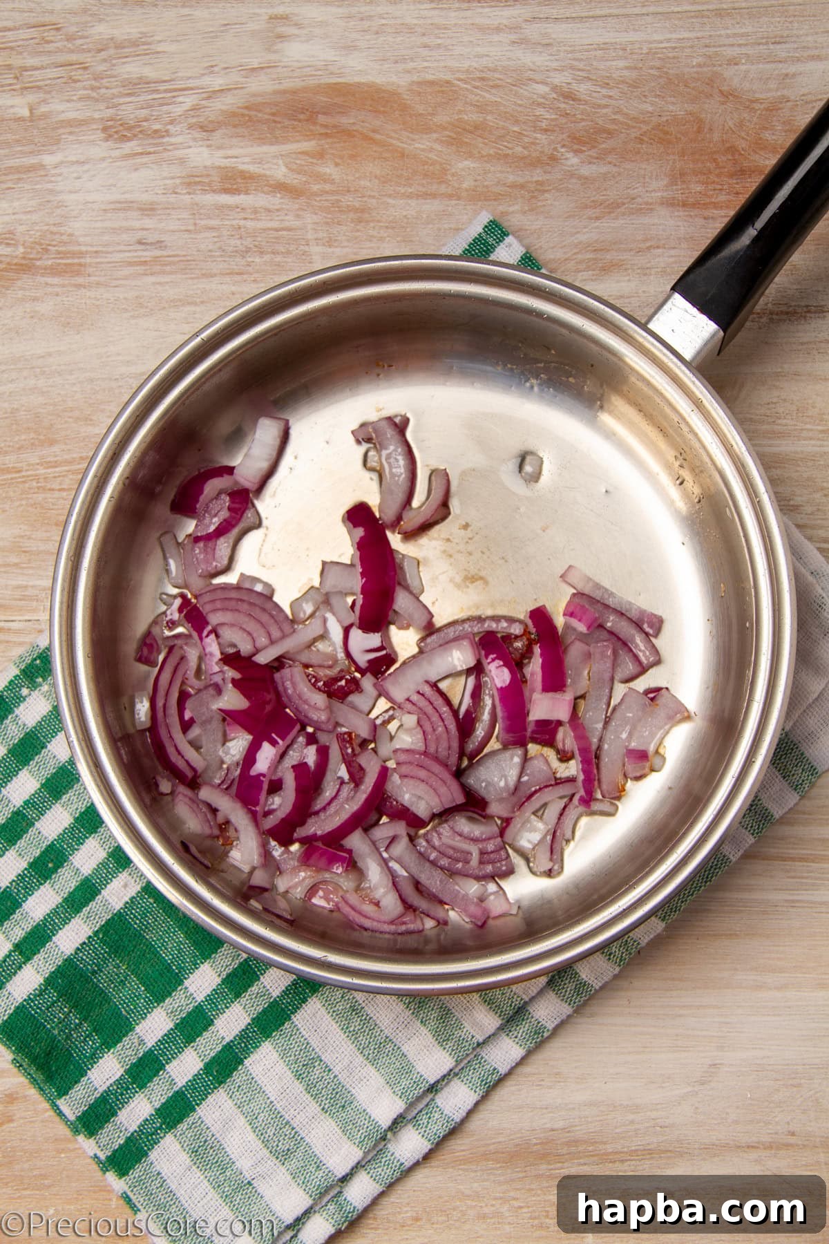 Delectable Mushroom Pizza 11 Sliced onions sautéing in a pan until translucent and lightly caramelized.