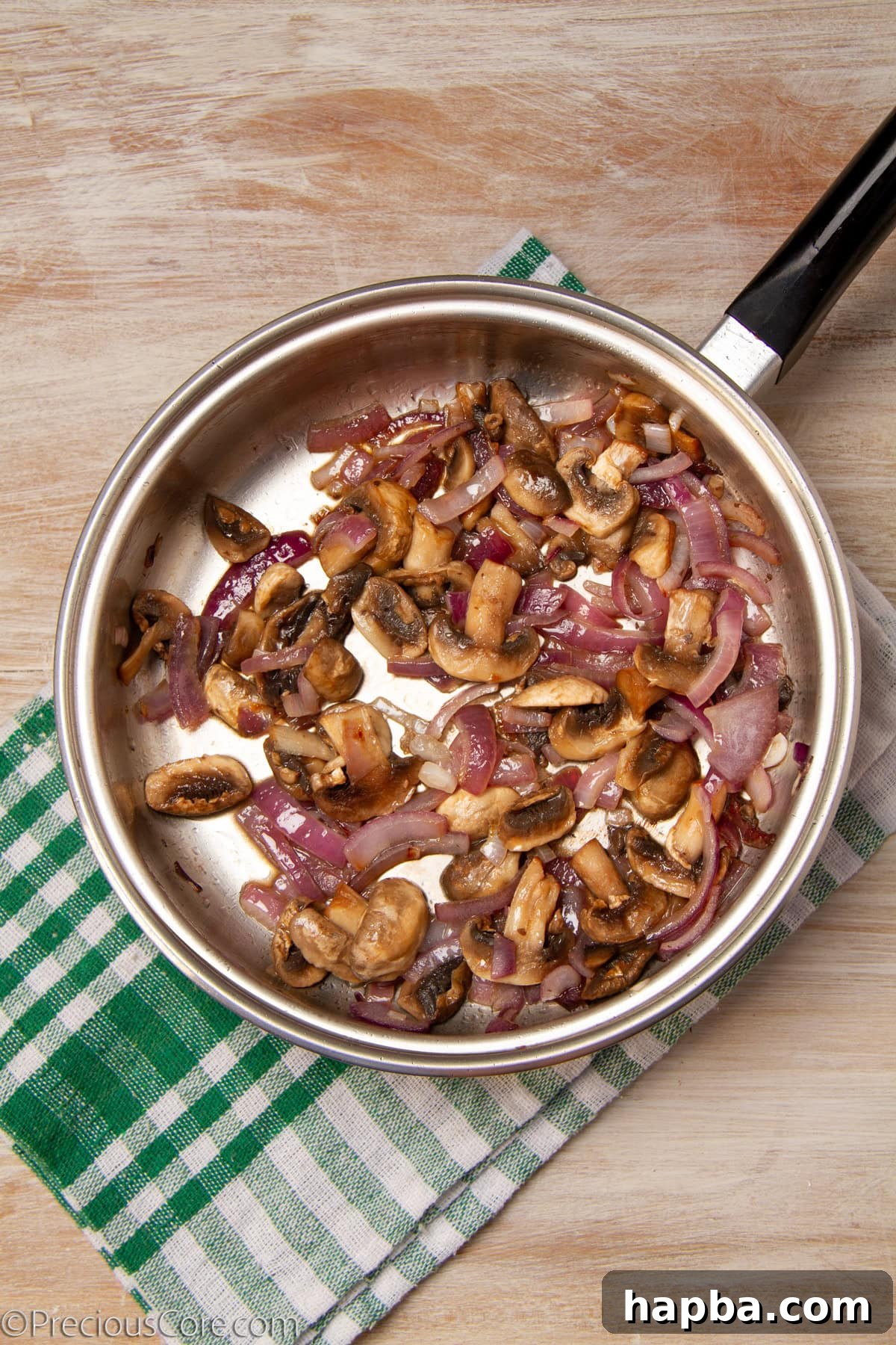 Delectable Mushroom Pizza 12 Sautéed onions and mushrooms cooking together in a pan, turning golden brown.