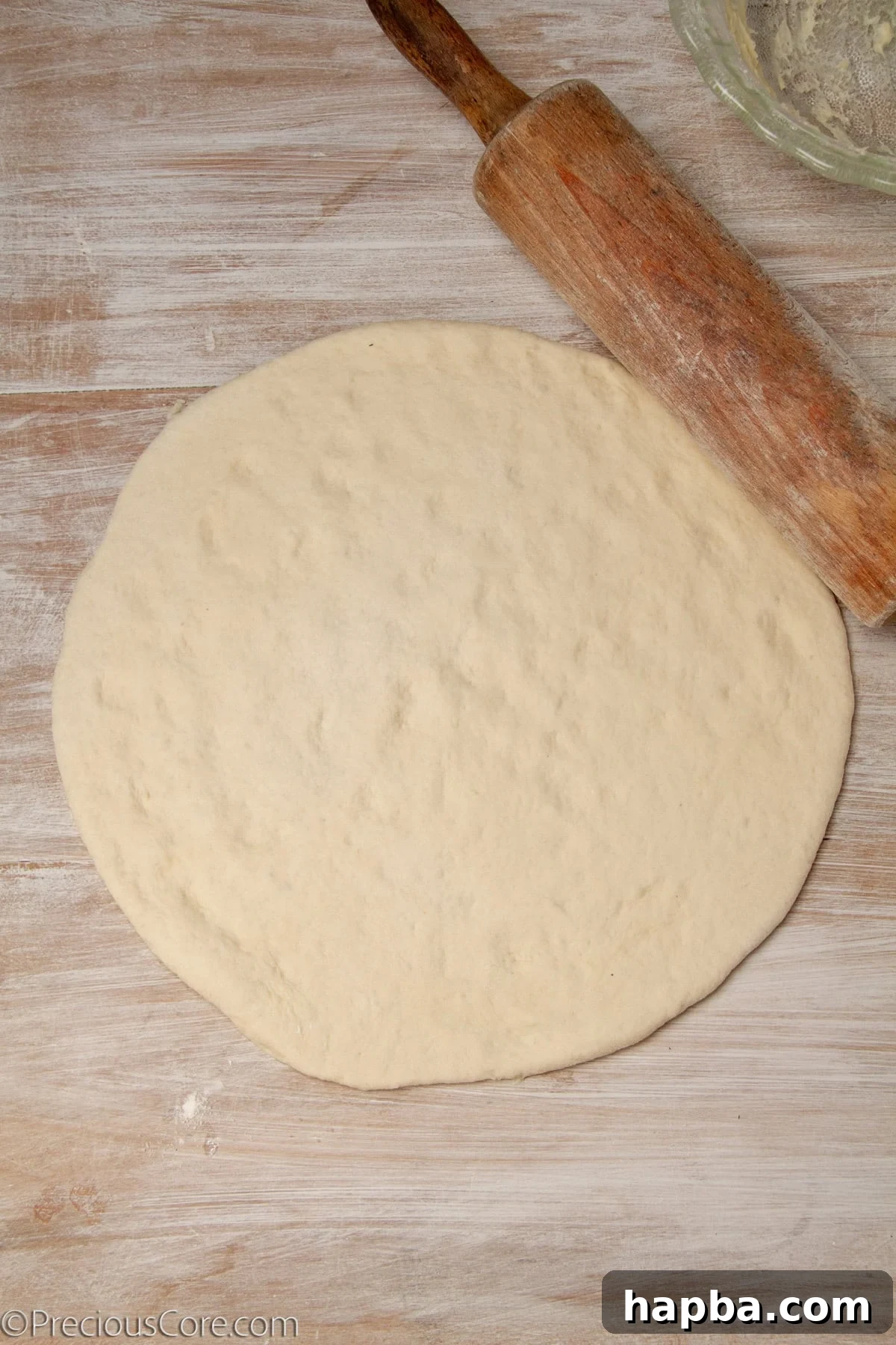 Delectable Mushroom Pizza 13 Pizza dough rolled out into a large circular shape on a surface.