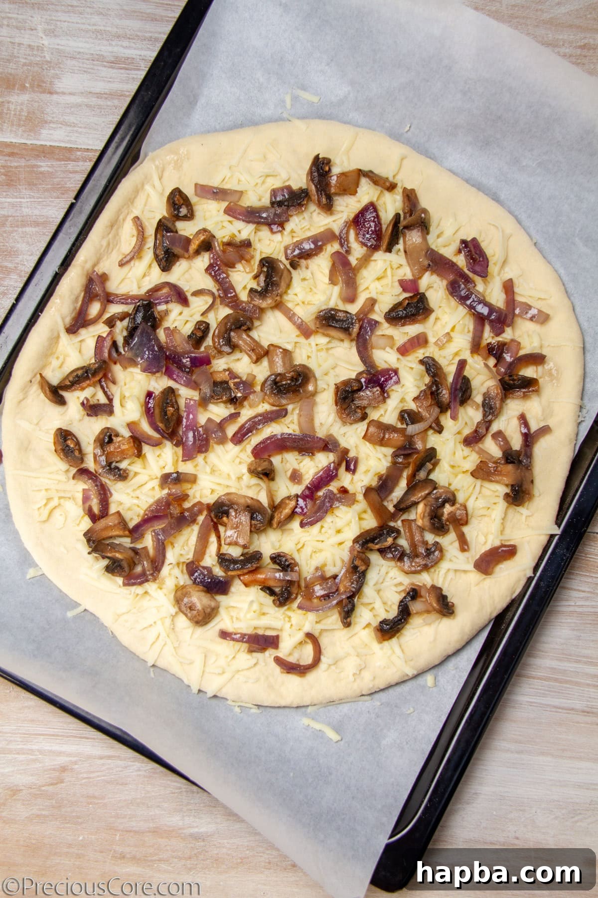Delectable Mushroom Pizza 14 Uncooked pizza generously topped with sautéed mushrooms, caramelized onions, and layers of mozzarella cheese.