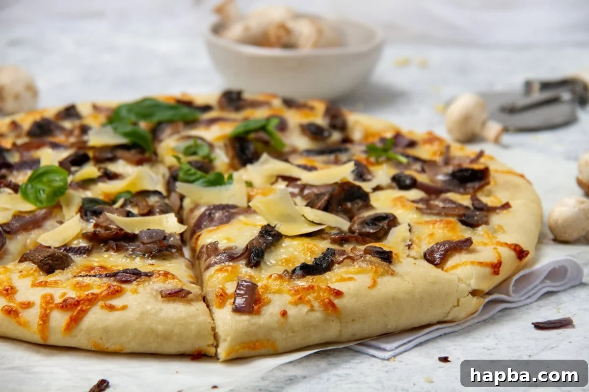 Delectable Mushroom Pizza 16 Landscape image of a whole mushroom pizza, garnished with fresh basil, ready to be cut into slices.