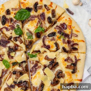 Pizza topped with mushrooms and fresh basil.
