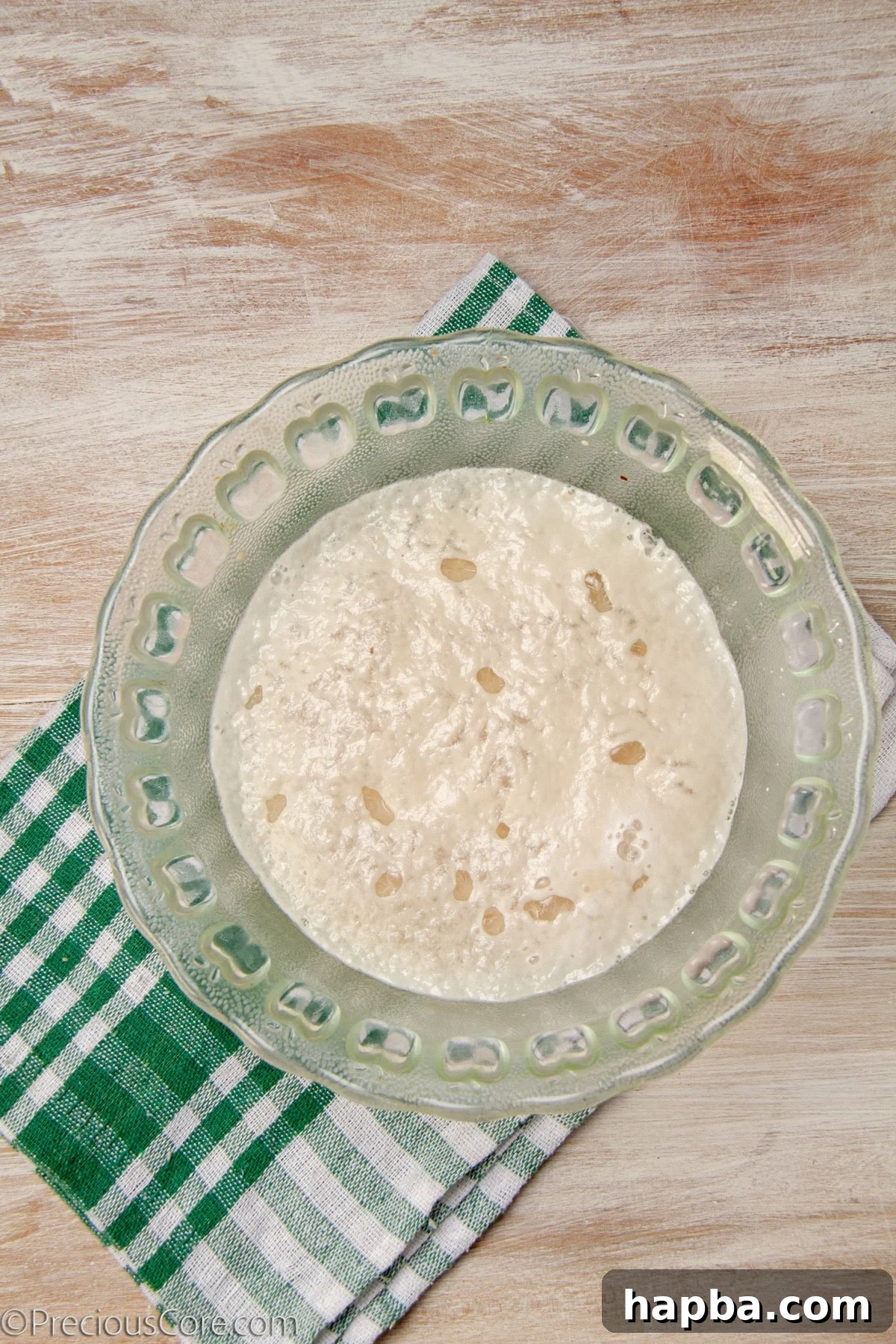 Delectable Mushroom Pizza 7 Frothy yeast and water mixture in a bowl, showing active yeast.