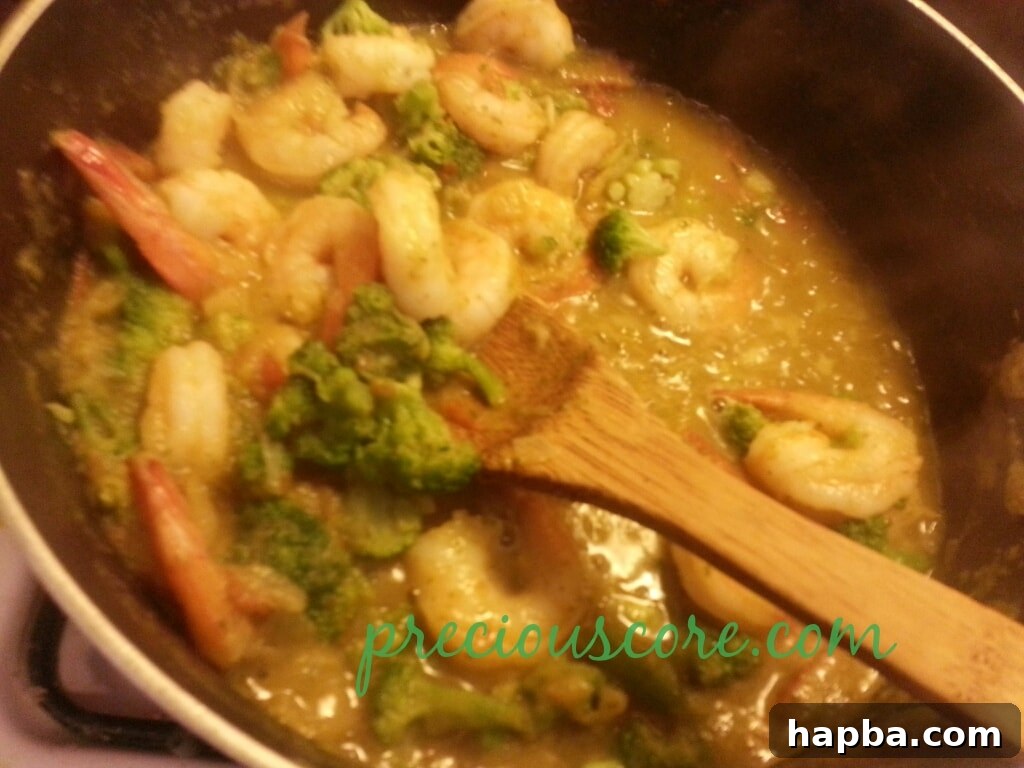 Mixed vegetables added to the pan with shrimp and sauce.