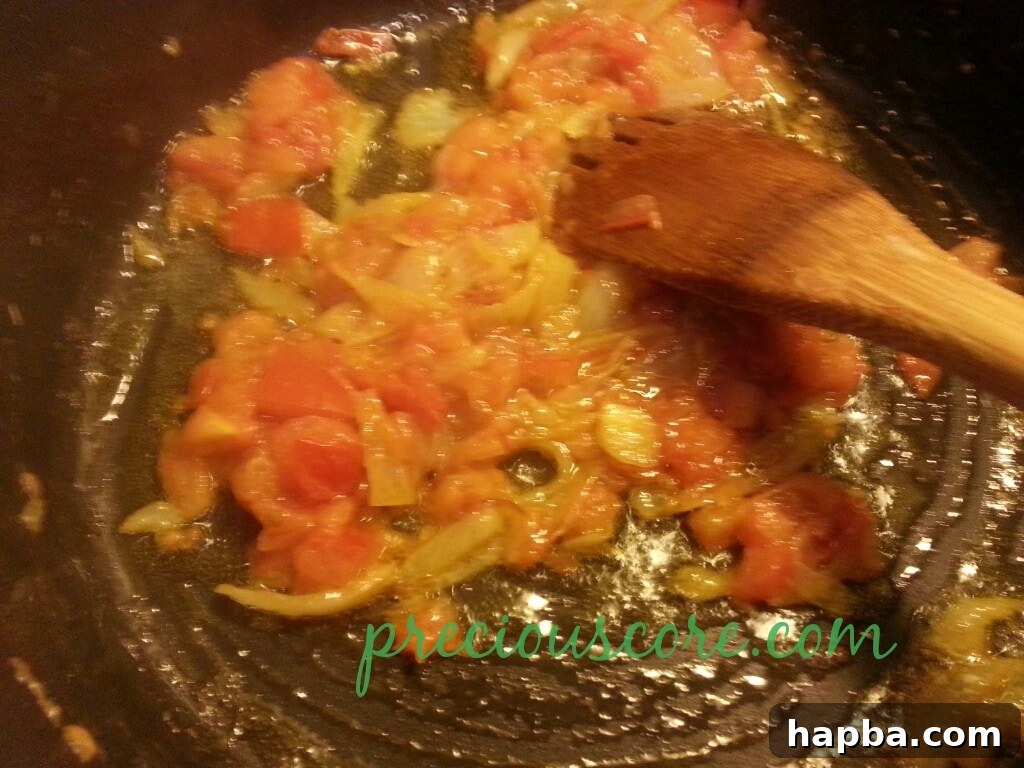Garlic, ginger, and celery paste along with seasoning cube added to the tomato base.