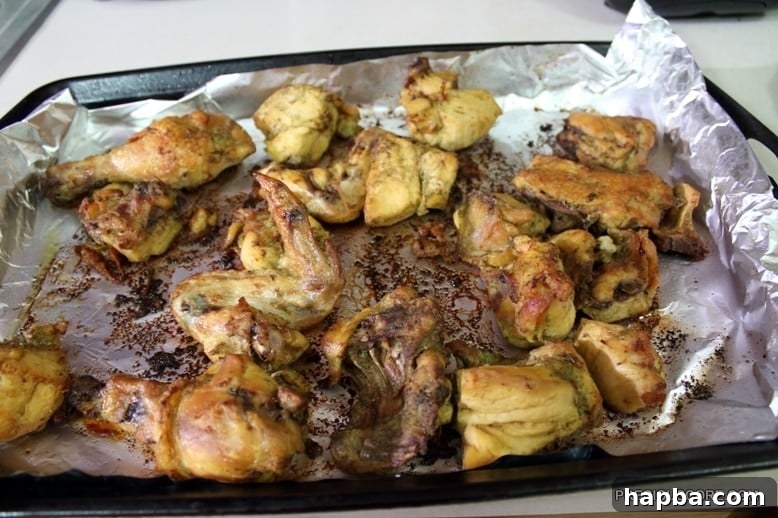 Oven grilled chicken in a lined baking dish.