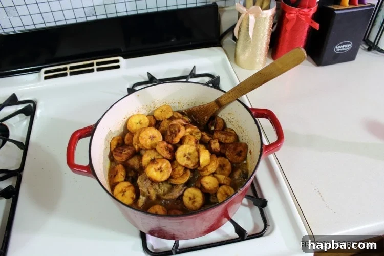 Plantains in a red Dutch oven with chicken.