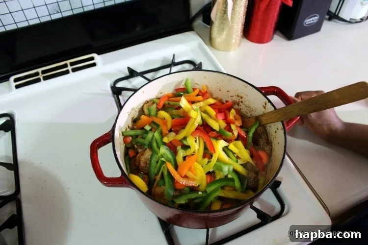 Colorful vegetables in a Dutch oven with chicken.