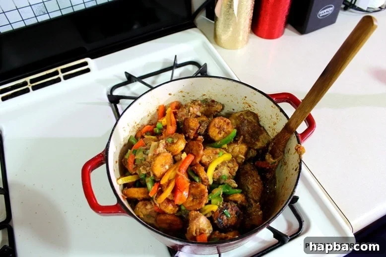 Wooden spoon in a Dutch oven of poulet DG.