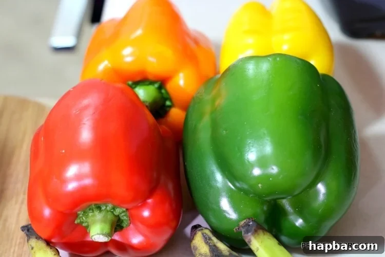 Red, green, orange, and yellow bell pepper.