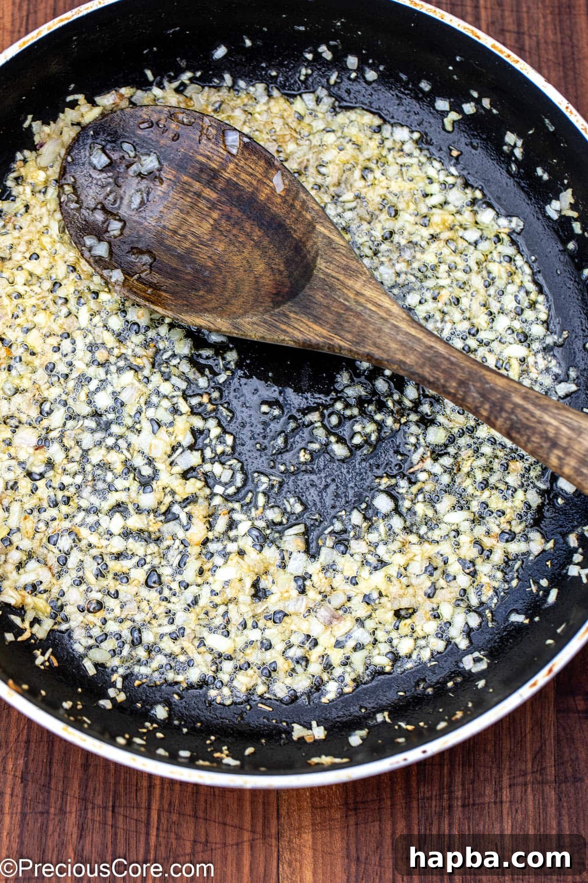 Sautéed shallots and garlic sizzling gently in a large skillet, forming the flavor base.