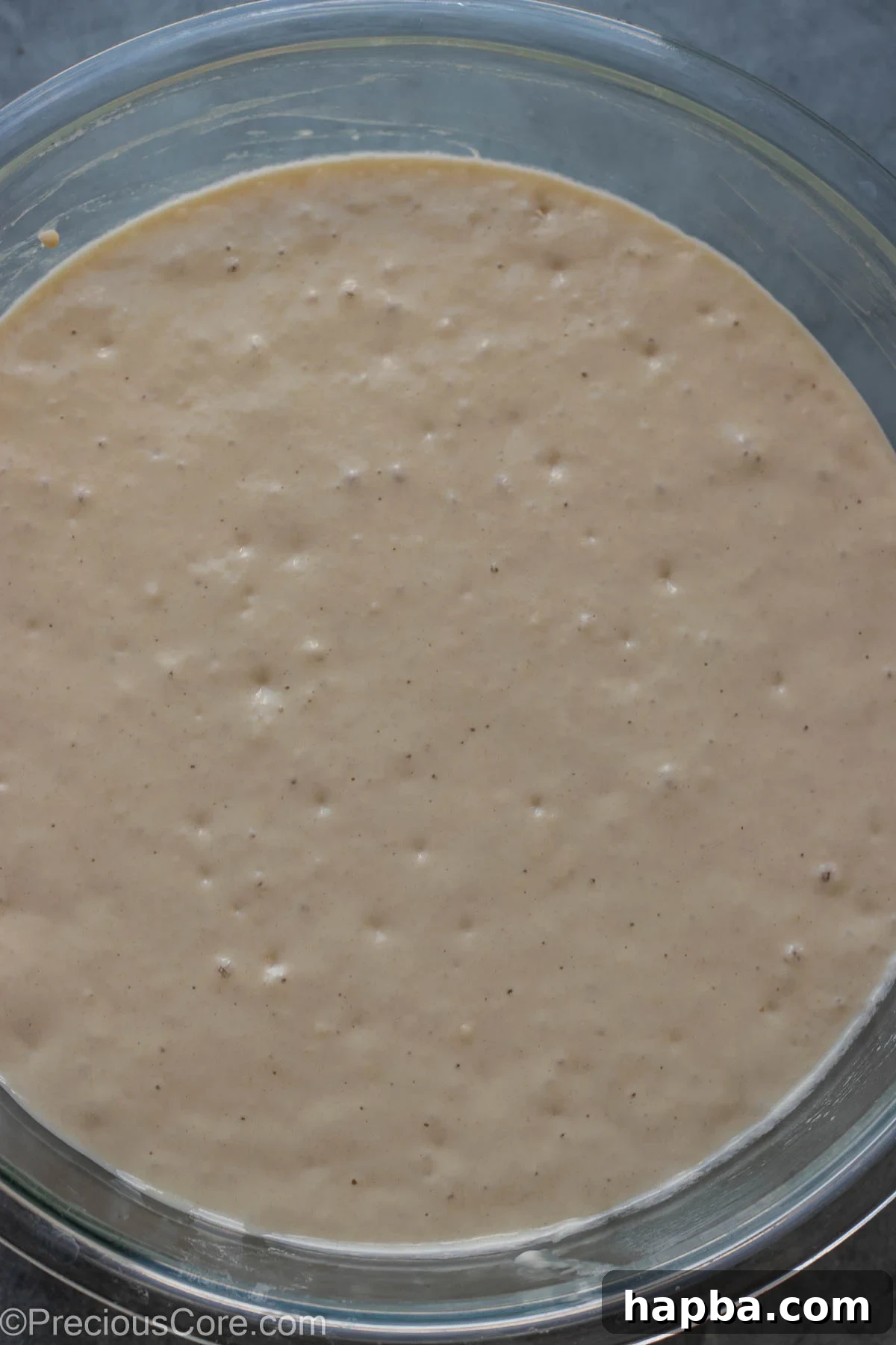 Puff Puff batter after rising, showing a significant increase in volume and bubbles on the surface.