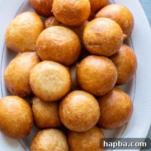 Puff Puff on a white tray, showcasing their fluffy texture and golden brown color.
