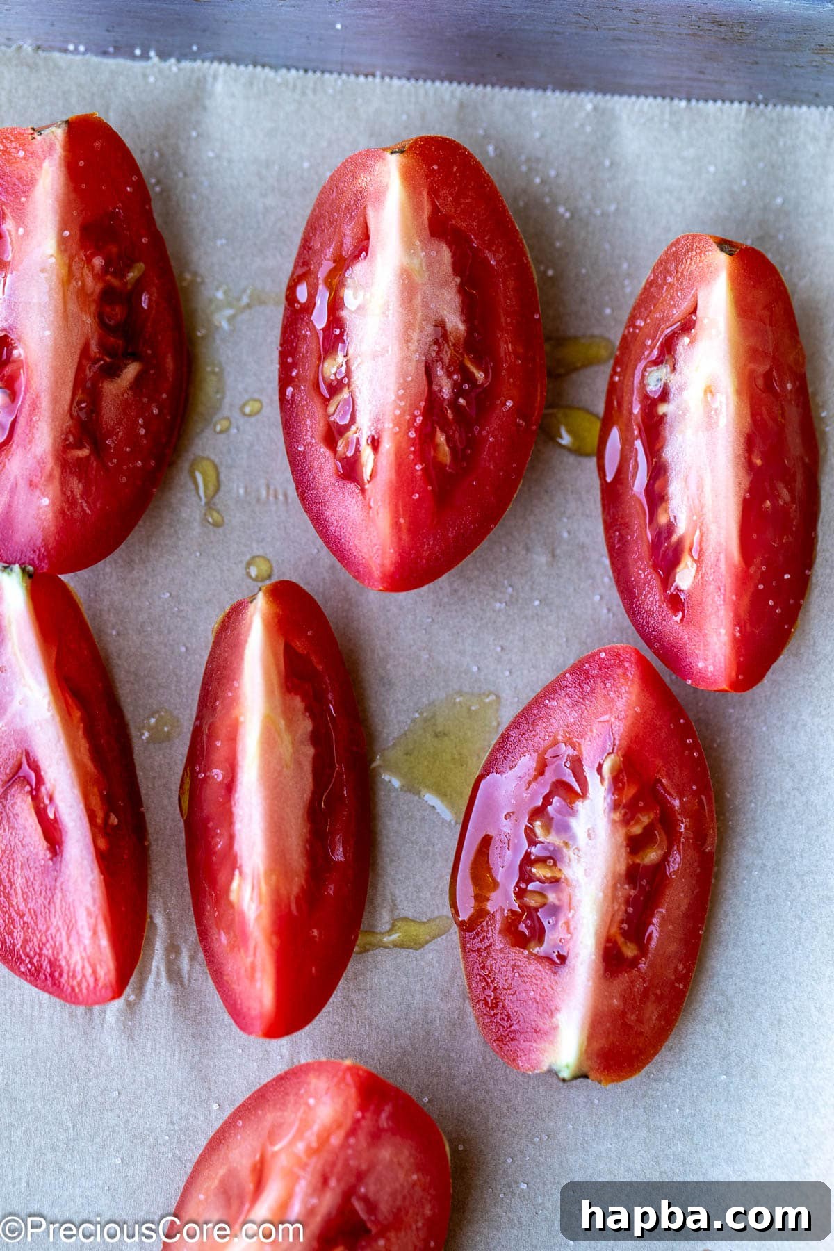 Tomato quarters drizzled with olive oil and sprinkled with salt.