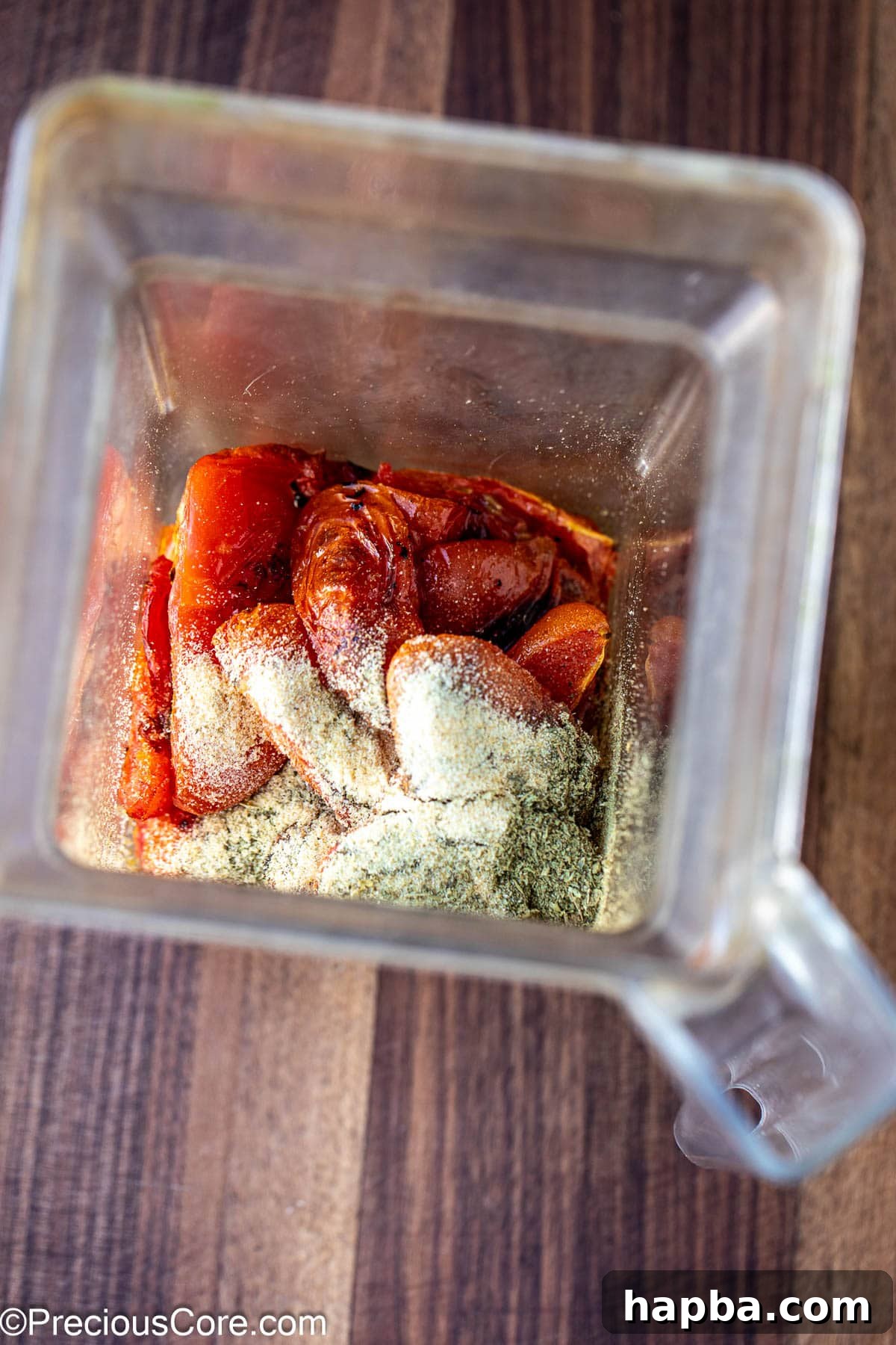 Roasted tomatoes and spices in a blender.