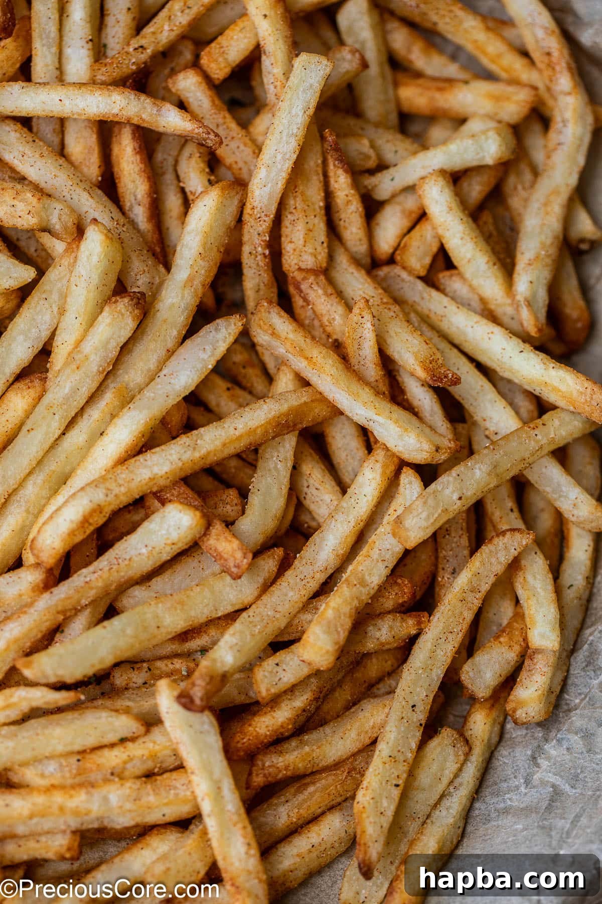 Fries with some seasoning sprinkled on top.