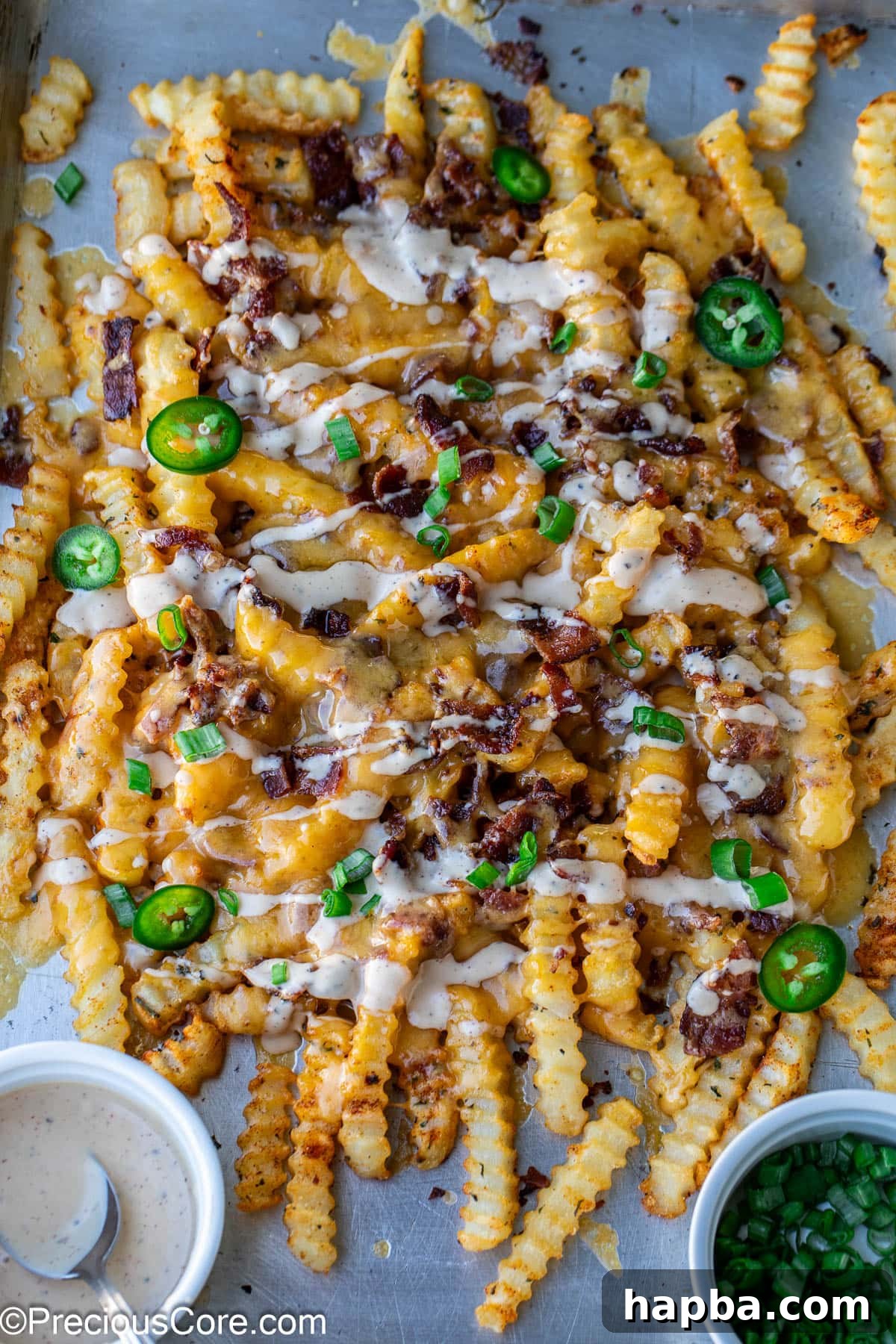 Delicious Loaded French Fries on a sheet pan, ready to serve.