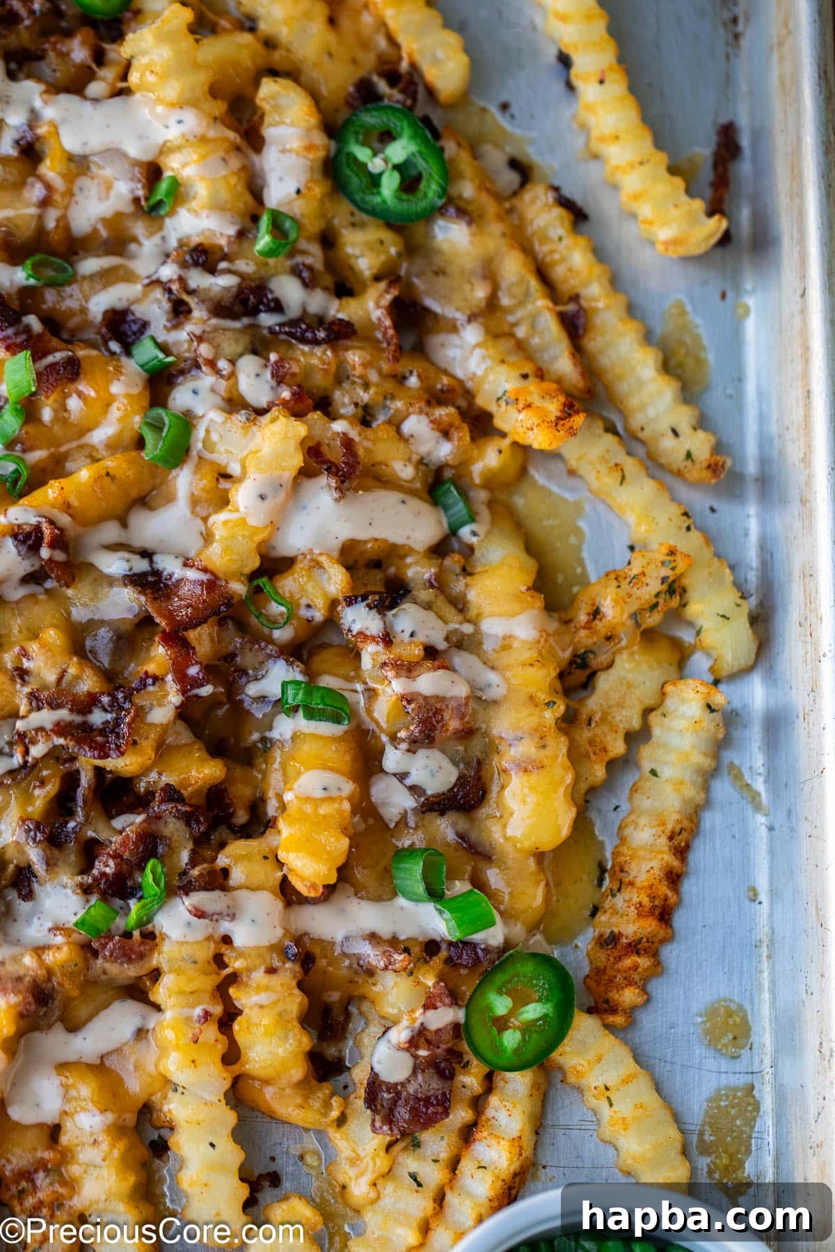 Crispy French fries completely covered with a generous layer of hot, melty cheese.