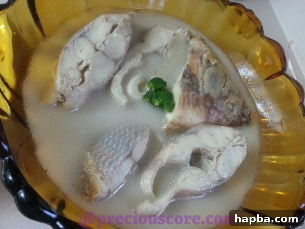 Close-up of Fish Pepper Soup, showcasing its rich broth and spices.