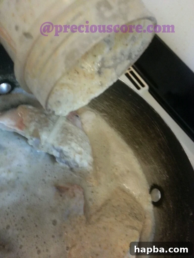 Blended spices and aromatics being added to the pot with fish.