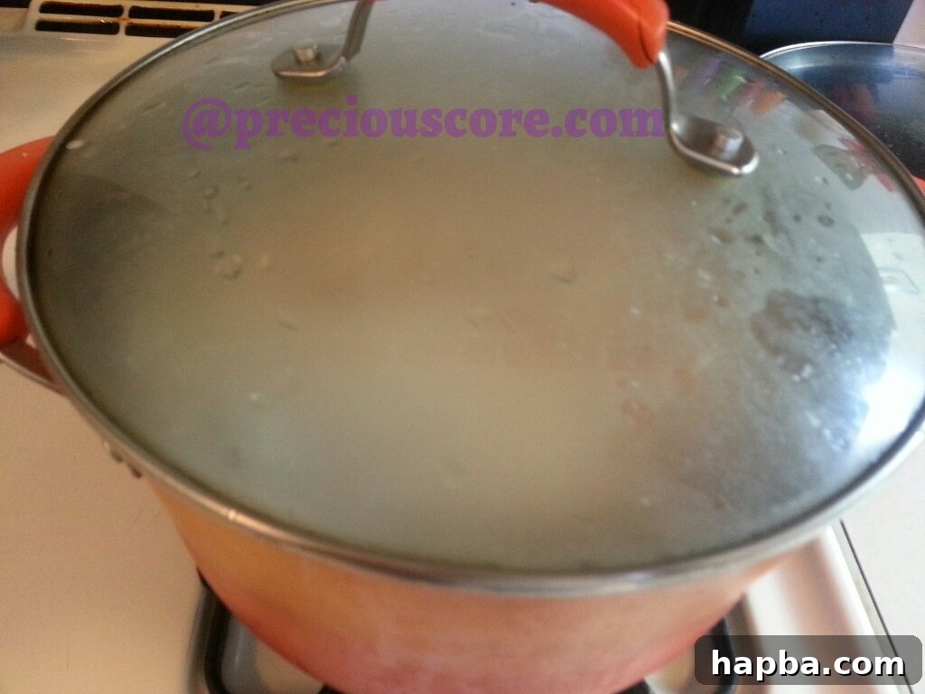 Cameroonian Fish Pepper Soup simmering on the stove.