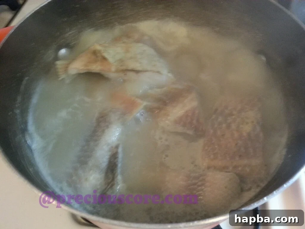 A steaming bowl of freshly prepared Cameroonian Fish Pepper Soup, ready to be served.