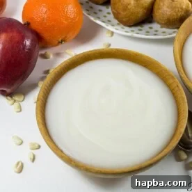 A warm wooden bowl showcasing a generous serving of Pap, the fermented corn porridge, a staple African breakfast.