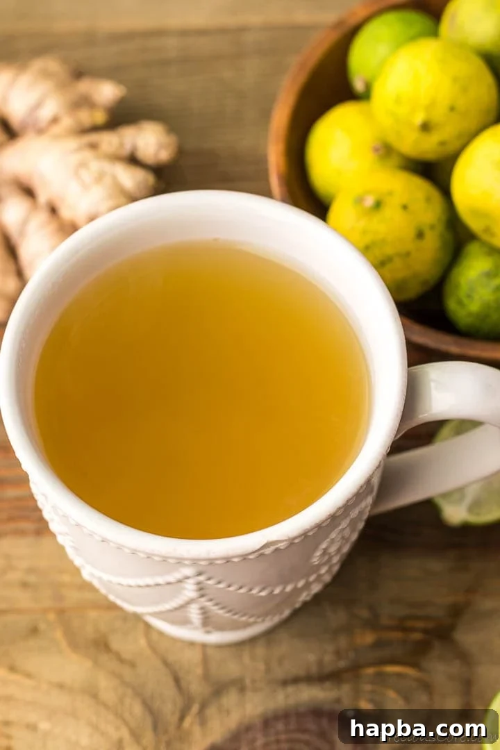 A white mug filled with a warm, inviting ginger drink, perfectly brewed for a comforting sip.
