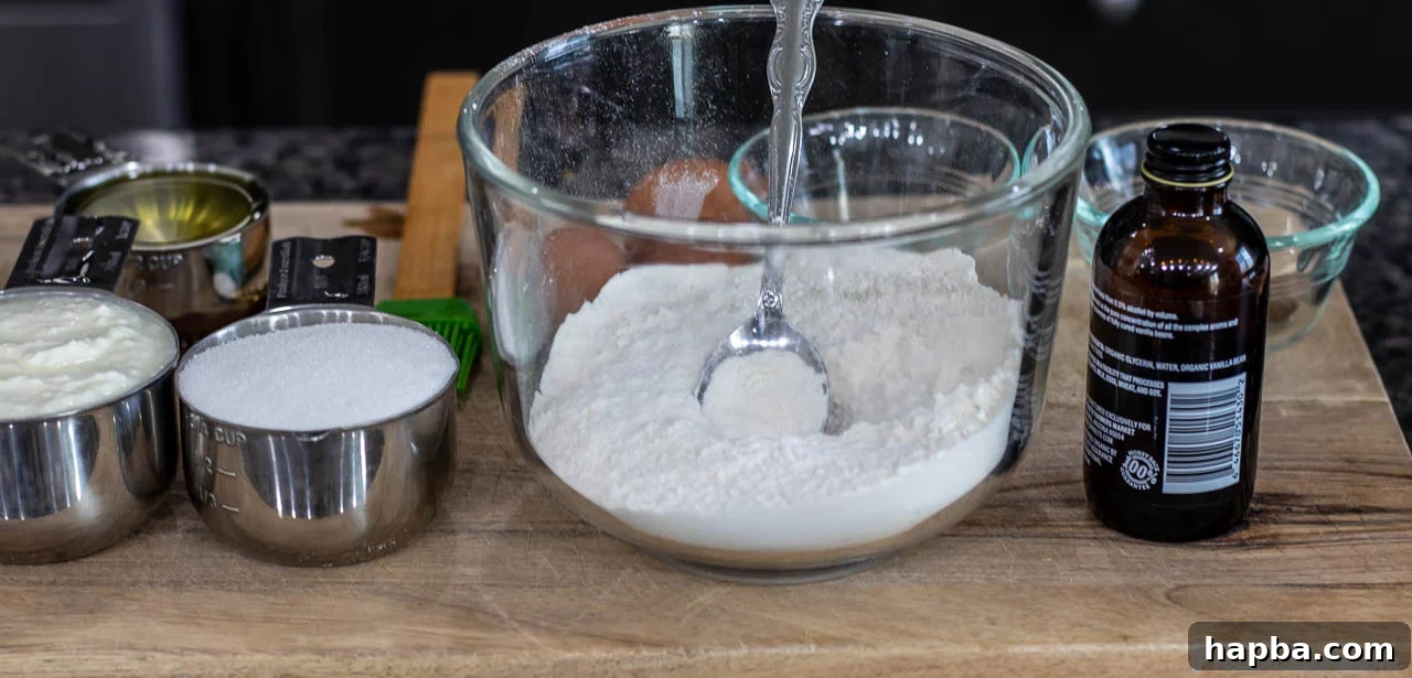 Velvet Yogurt Cake 4 All the essential ingredients for yogurt cake laid out on a wooden board.
