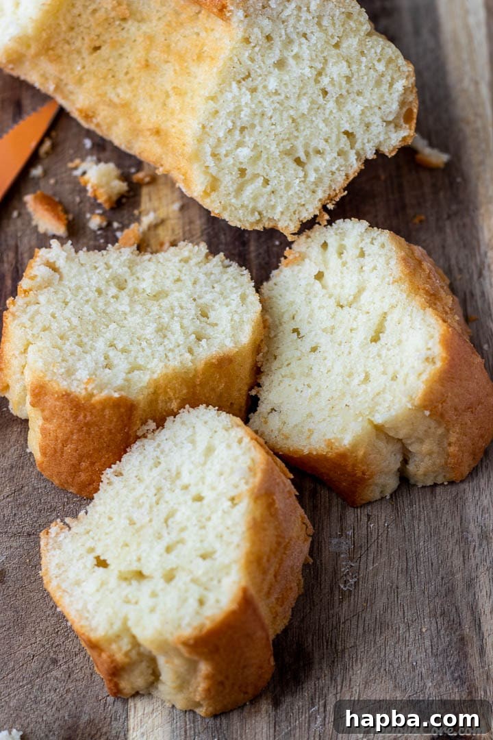 Velvet Yogurt Cake 6 Multiple slices of yogurt cake arranged neatly on a wooden chopping board.