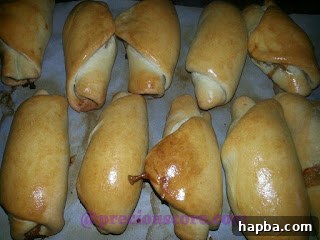 Perfectly baked golden-brown chicken rolls fresh out of the oven.