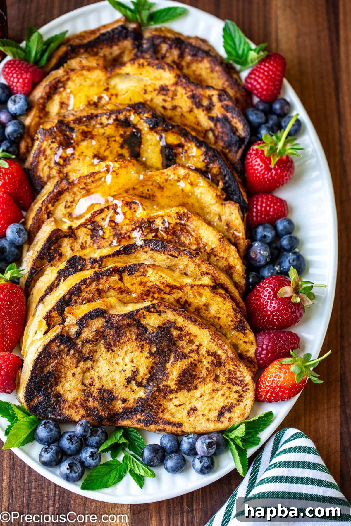 Slices of Sourdough French toast on a white oval plate.
