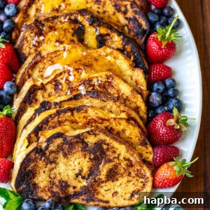 Slices of Sourdough French toast on a white oval plate.