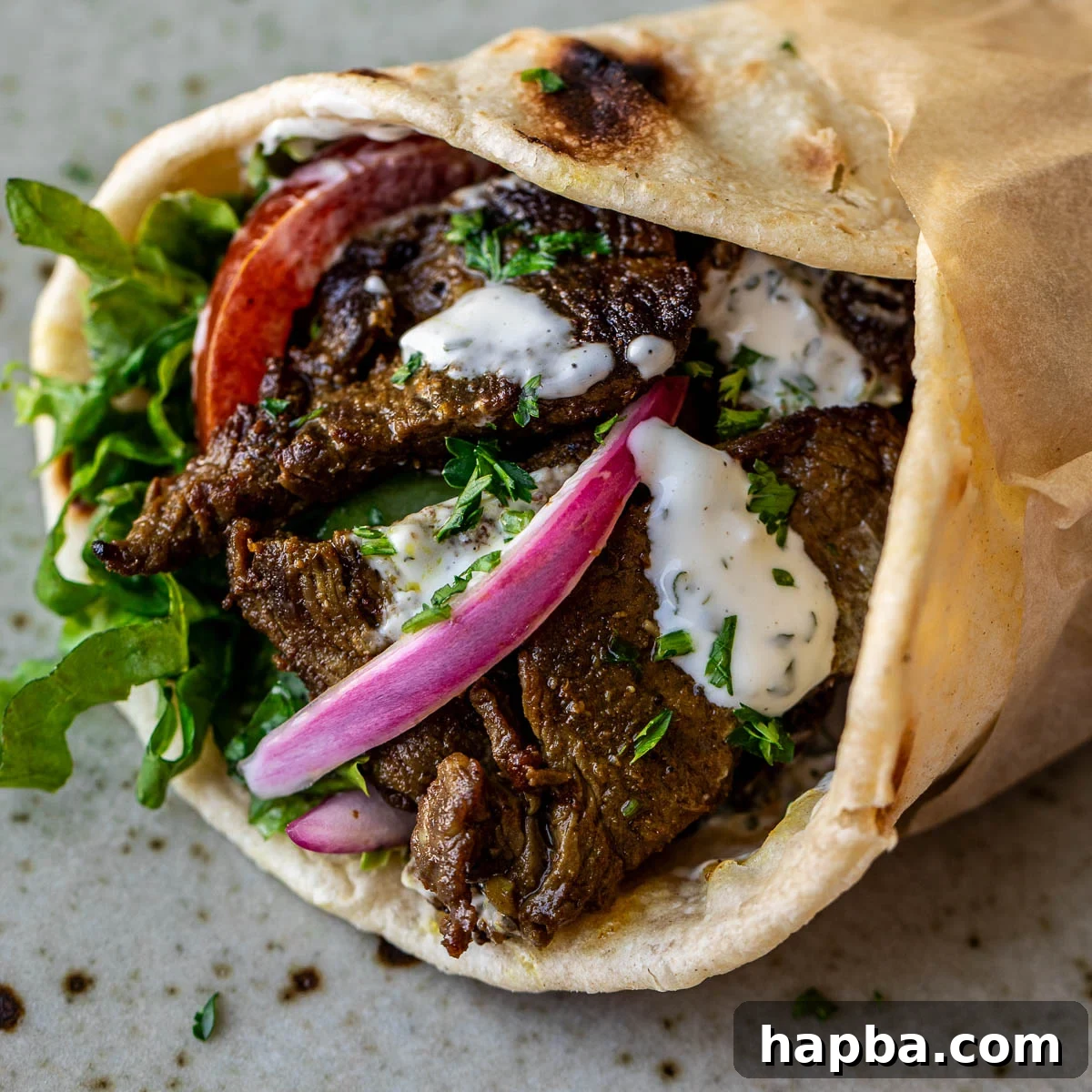 Close up image of beef shawarma wrap.