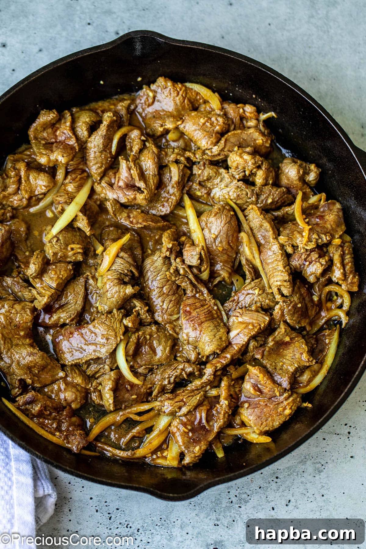 Restaurant-Style Beef Shawarma at Home 7 Marinated beef shawarma cooking in a single layer in a hot skillet.