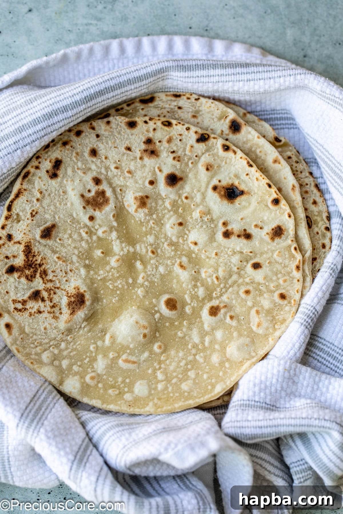 Shawarma Flatbread 2 Freshly baked shawarma bread on a rustic linen cloth, indicating its soft and pliable texture.
