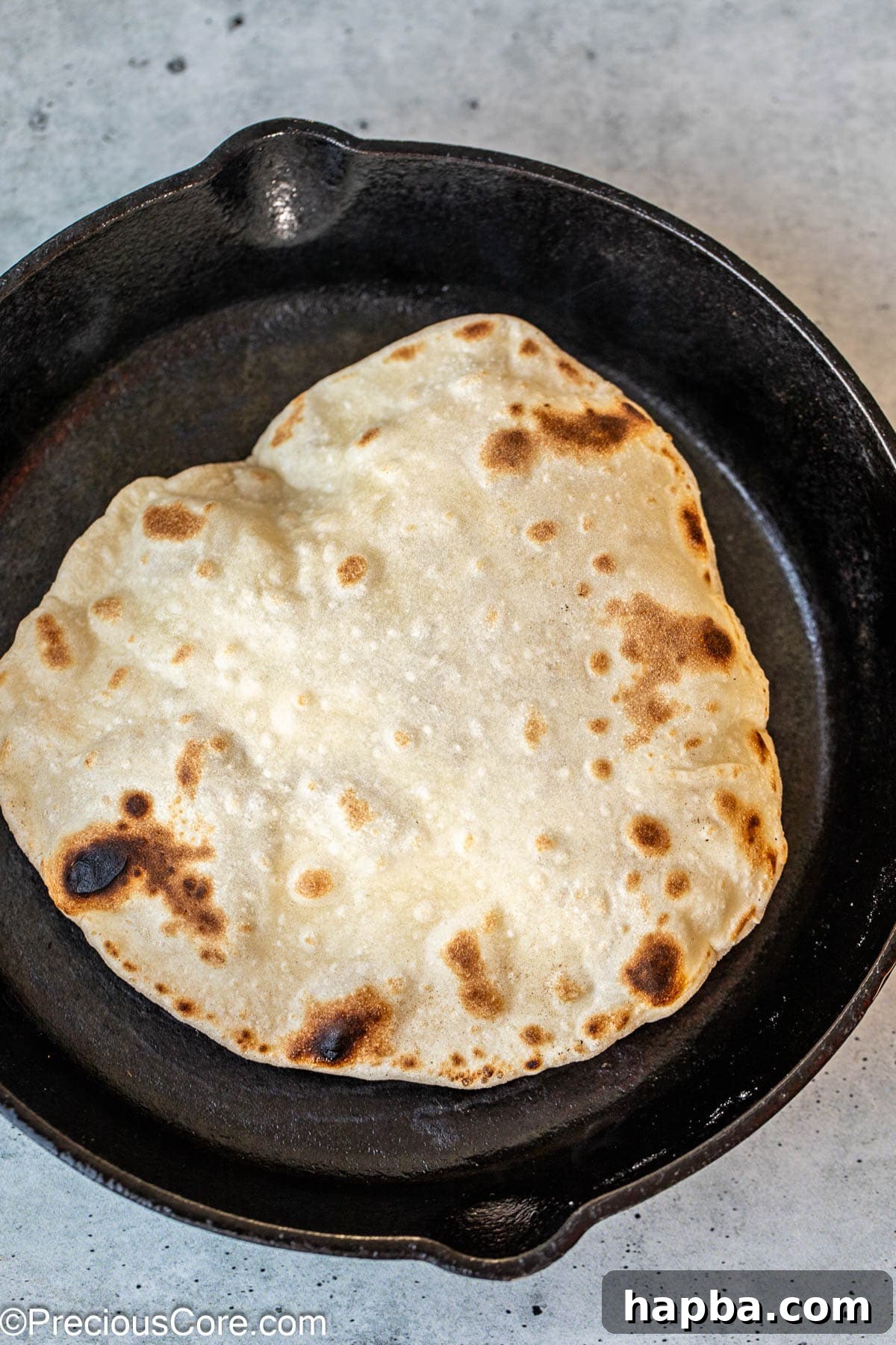 Shawarma Flatbread 11 Shawarma bread magnificently puffing up in a skillet, indicating proper cooking and creating a delightful airy texture.