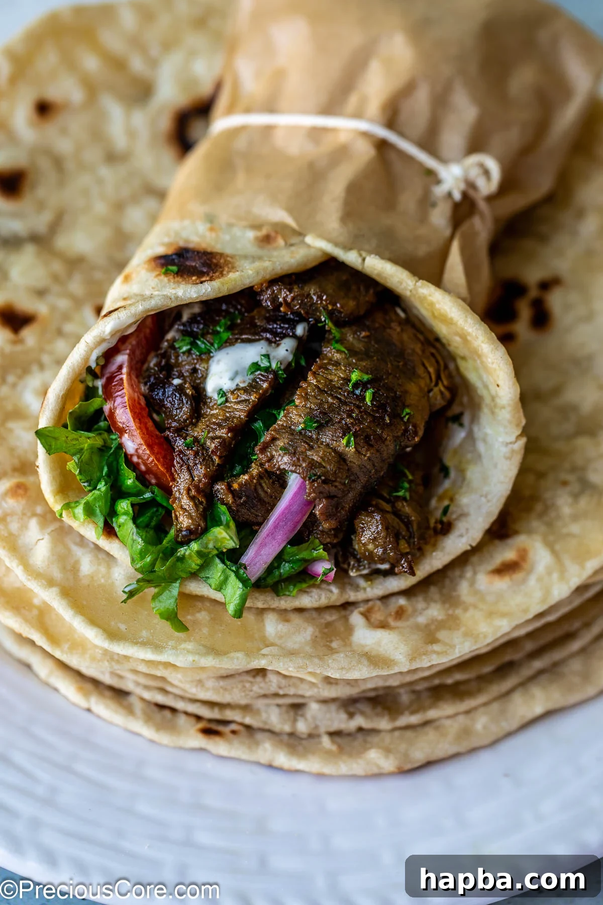 Shawarma Flatbread 4 A vibrant, freshly prepared beef shawarma wrap, highlighting the bread's role as a perfect carrier for fillings.
